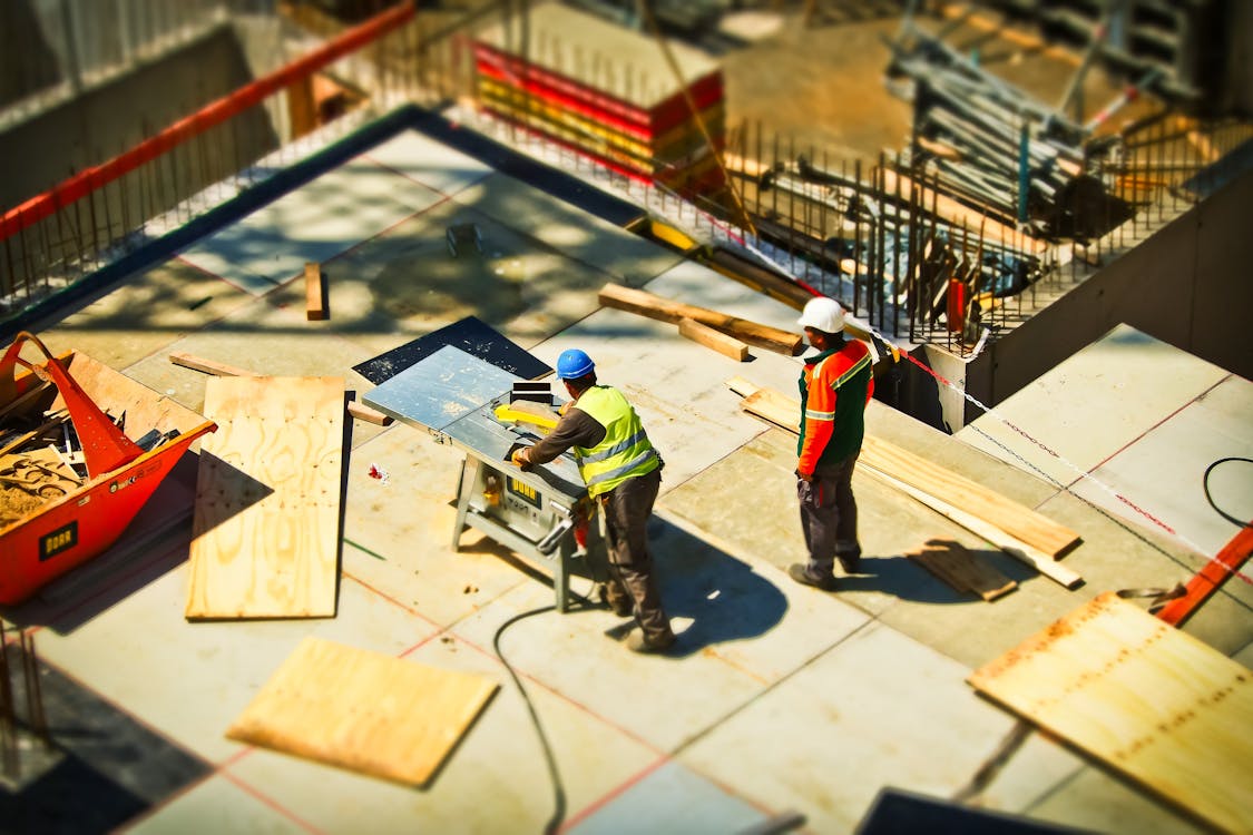 Construction site with workers and modern building